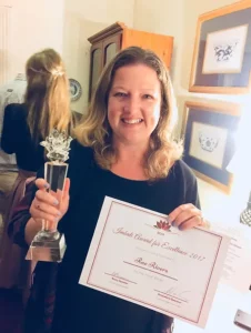 Rae Rivers holding the Imabali Award