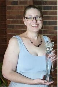 Author Romy Sommer holding the Imbali Award