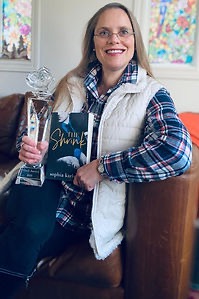 Author Sophia Karlson holding the Imbali Award